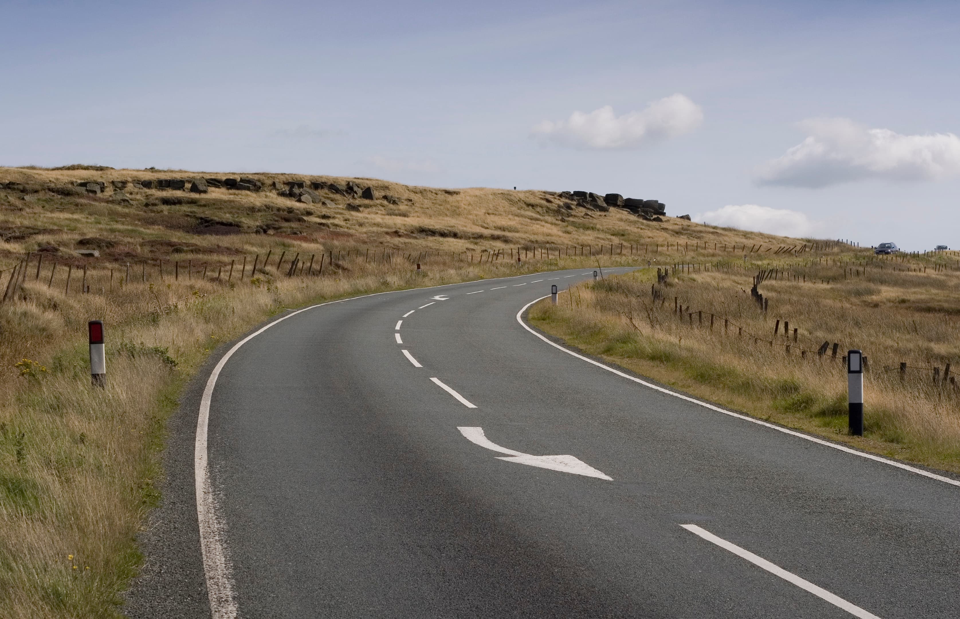 The A635 Holmfirth Road passes by Hollin Brown Knoll on Saddleworth Moor, Saddleworth, Greater Manchester, England. The rocks in the distance were mentioned by murderer Myra Hindley as visible during the burial of victim Pauline Reade.