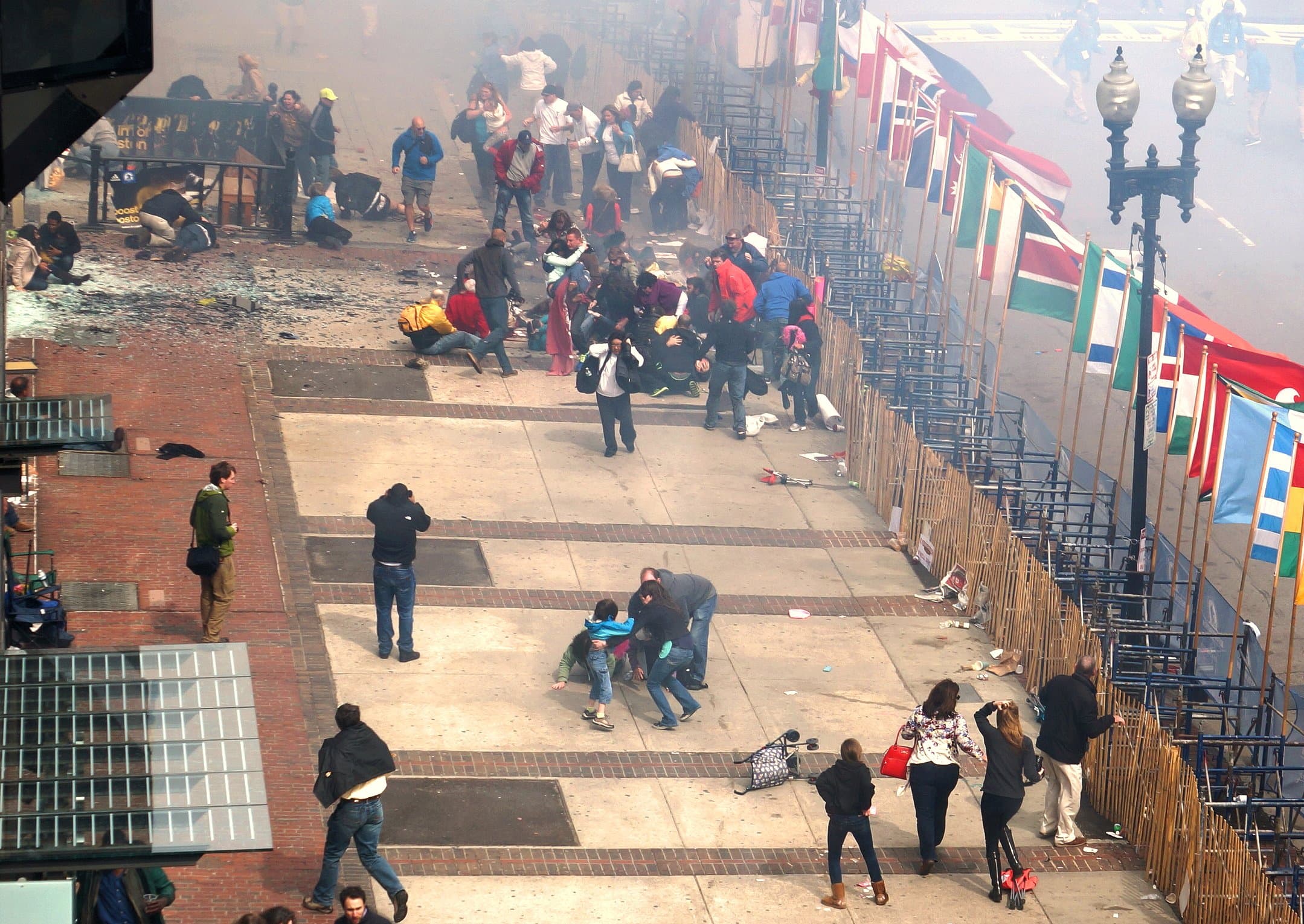 Spectators helping victims soon after the attack.