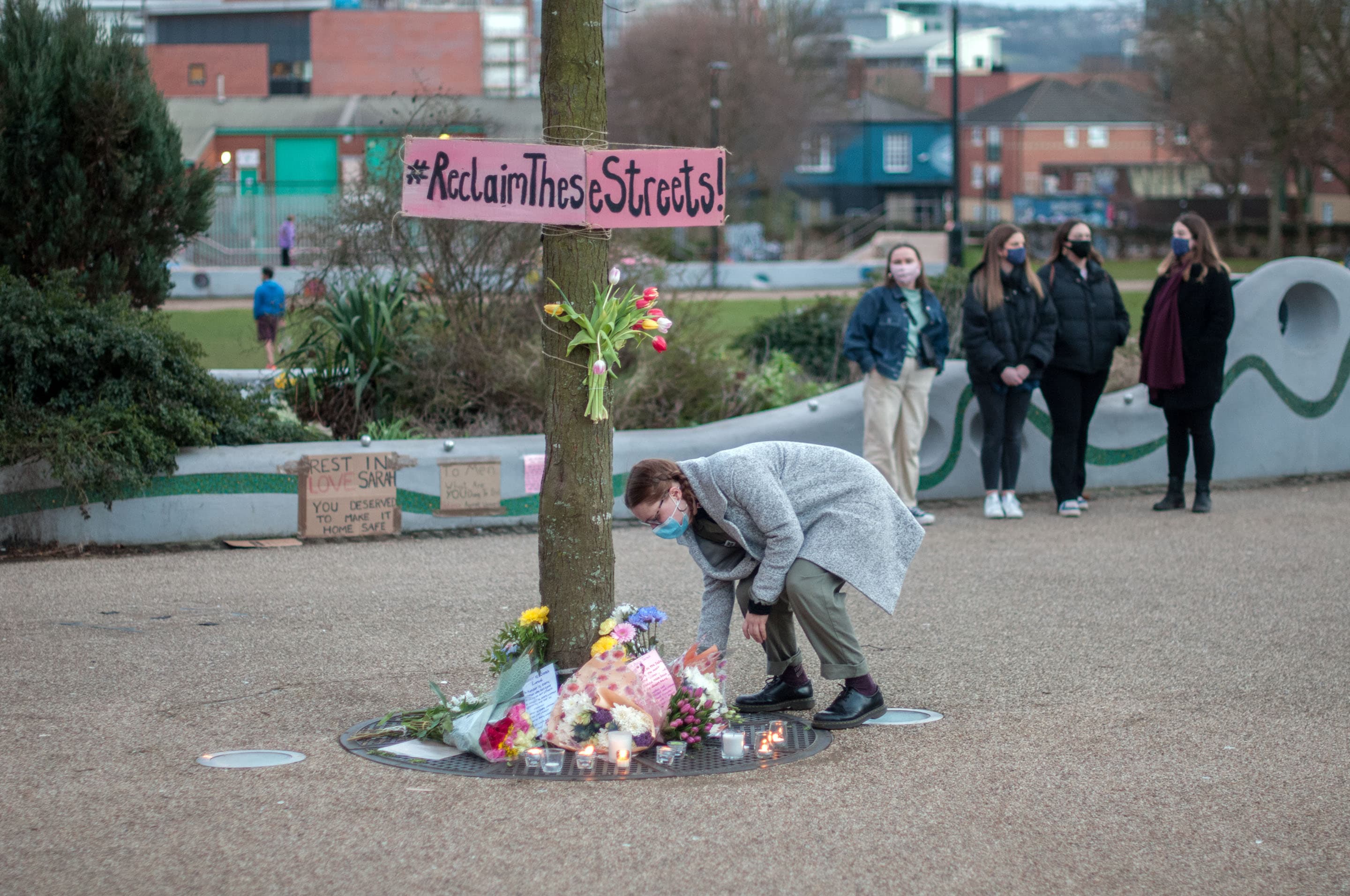 A woman lays flowers at a vigil for Sarah Everard in Sheffield, UK.