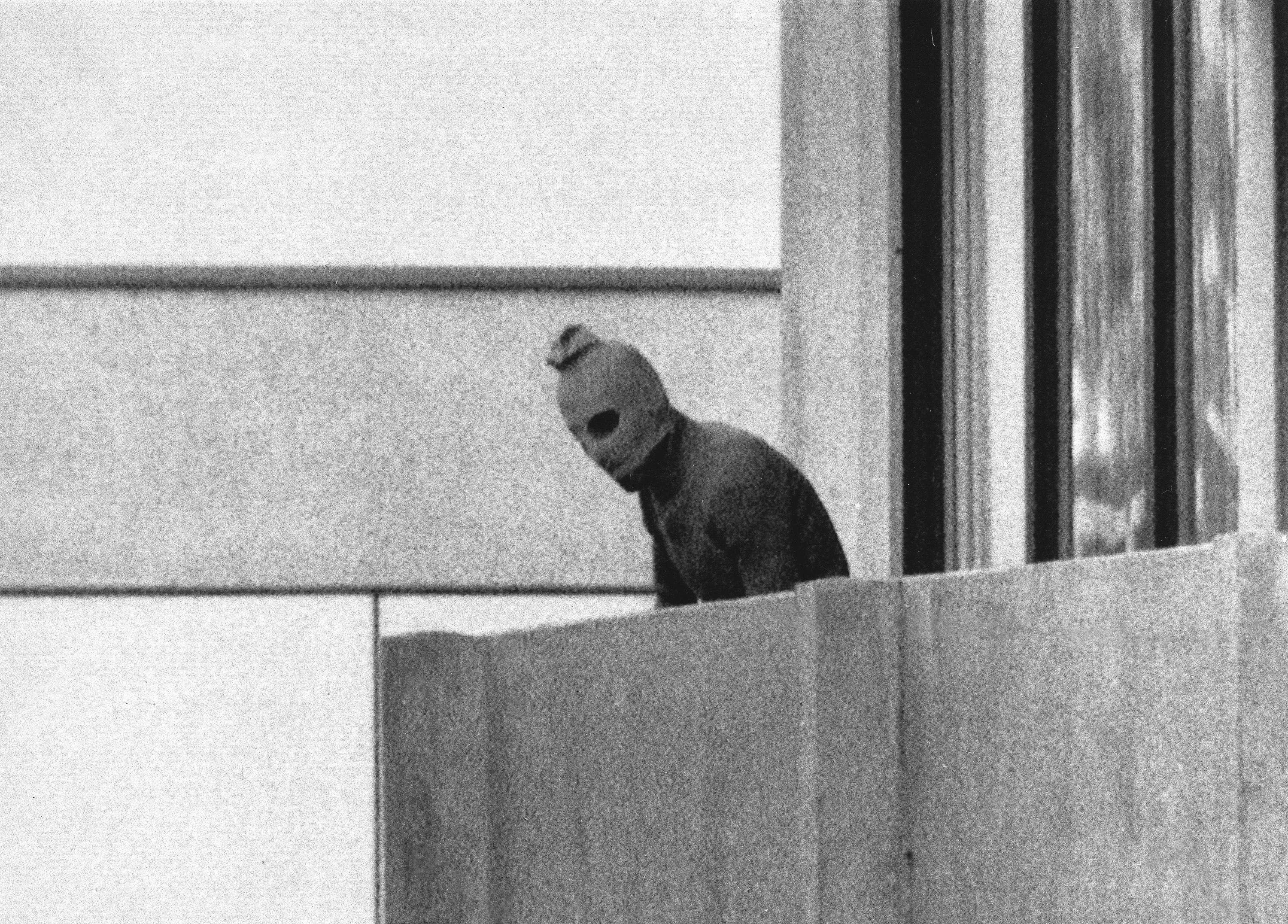 A member of the Arab Commando group which seized members of the Israeli Olympic Team at their quarters at the Olympic Village appearing with a hood over his face stands on the balcony of the building where the commandos held members of the Israeli team hostage in Munich, Sept. 5, 1972. The families of 11 Israeli athletes killed by Palestinian attackers at the 1972 Summer Olympics in Munich and the German government are close to reaching a deal over the long-disputed amount of the compensation.