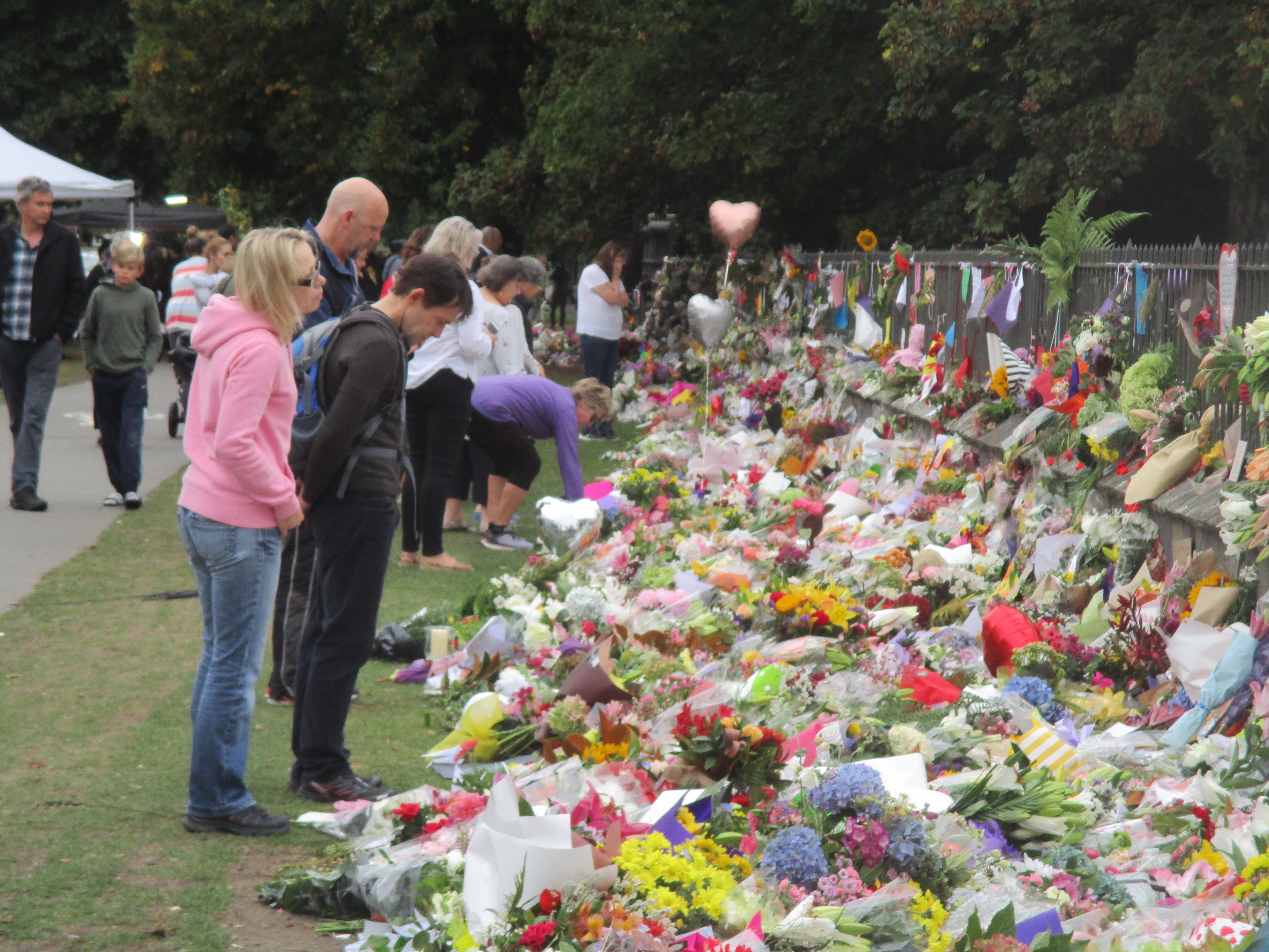 Members of the public laying flowers at a Christchurch mosque attack memorial