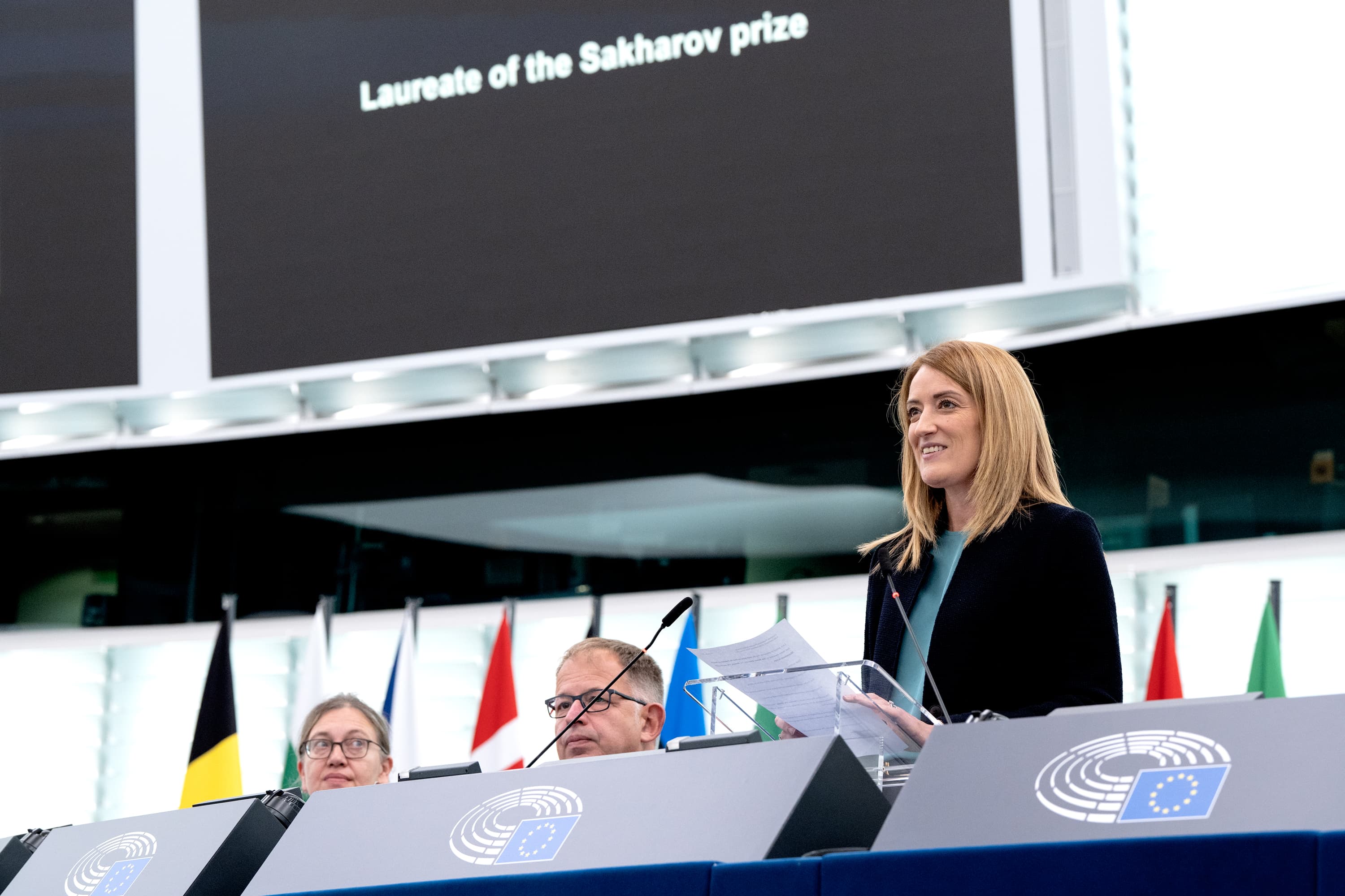 MEPs have awarded the 2023 Sakharov Prize for Freedom of Thought to Jina Mahsa Amini and the Woman, Life, Freedom Movement in Iran. European Parliament President Roberta Metsola announced the 2023 laureate in the Strasbourg plenary chamber on Thursday, following a decision by Parliament’s Conference of Presidents (President Metsola and political groups’ leaders). President Metsola declared: ʺOn 16 September we marked one year since the murder of Jina Mahsa Amini in Iran. The European Parliament proudly stands with the brave and defiant who continue to fight for equality, dignity and freedom in Iran. We stand with those who, even from prison, continue to keep Women, Life and Freedom alive. By choosing them as laureates for the Sakharov Prize for Freedom of Thought 2023, this House remembers their struggle and continues to honour all those who have paid the ultimate price for liberty.ʺ Jina Mahsa Amini was a 22-year-old Iranian Kurdish woman. She was arrested by police in Tehran on 13 September 2022 for allegedly ignoring Iran’s strict veiling laws, and died in a Tehran hospital three days later following physical abuse while in custody. Her death sparked massive women-led protests in Iran. Under the slogan “Woman, Life, Freedom”, they have been protesting against the hijab law and other discriminatory laws. Following the Iranian regime’s brutal crackdown on these protests, the European Parliament has repeatedly condemned the dire human rights situation in the country. In October 2022, MEPs called for sanctions against Iranian officials involved in both Jina Mahsa Amini’s death and the regime’s repression, and expressed their strong support for the peaceful protest movement in Iran. In January 2023, MEPs demanded more sanctions against the Iranian regime and for the EU to place the Islamic Revolutionary Guard Corps on its terrorist list. Read more: ____ This photo is free to use under Creative Commons license CC-BY-4.0 and must be credited: "CC-BY-4.0: © European Union 2023 – Source: EP".