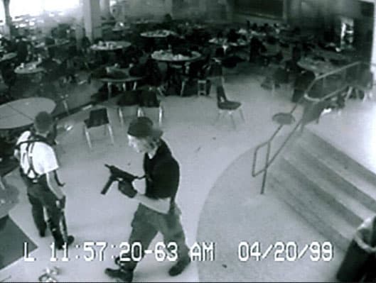 A black and white still image taken from the security video of Columbine High School during the shooting, showing Eric Harris and Dylan Klebold.